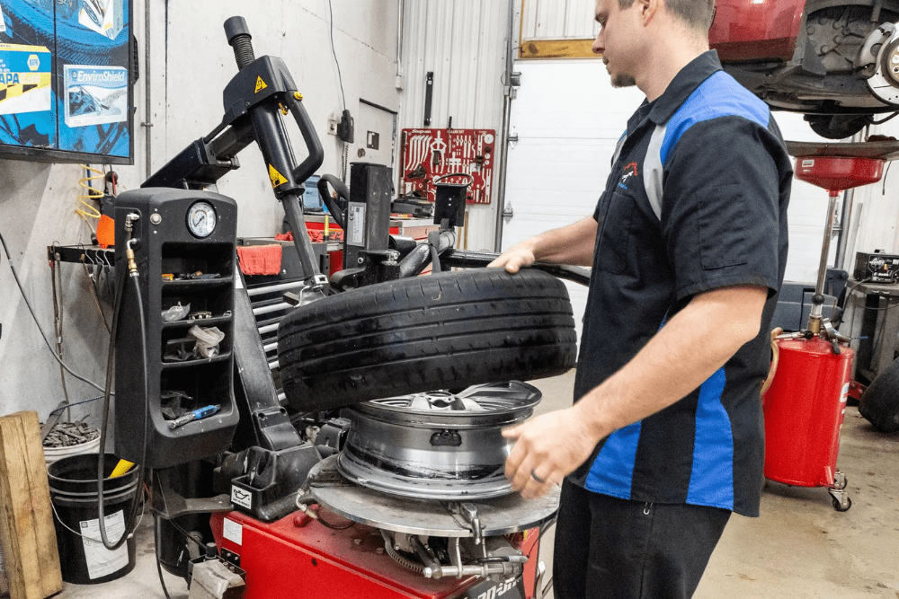 Car maintenance, auto repair in Glen Rock, PA by Cain and Sons’ Automotive. Image of a technician mounting a tire using professional equipment, emphasizing precision, safety, and quality care for every vehicle.