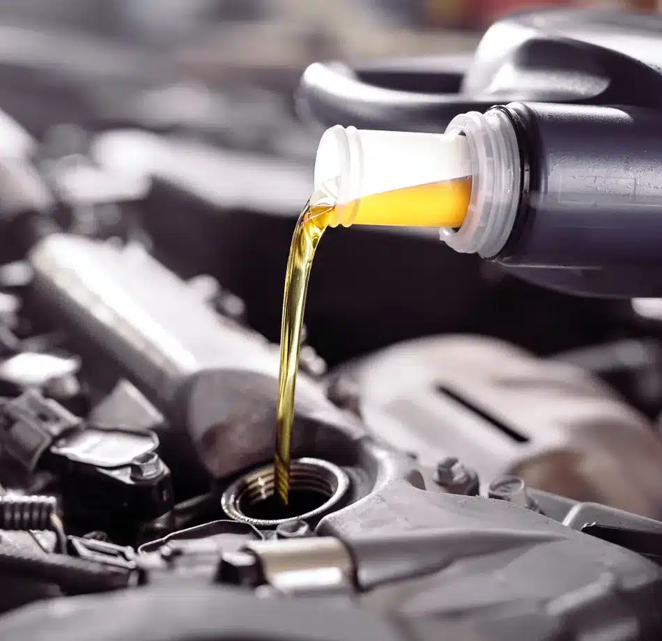 Motor oil being poured into an engine at Cain and Sons’ Automotive in Glen Rock, PA, part of preventive maintenance that supports reliable ADAS system operation