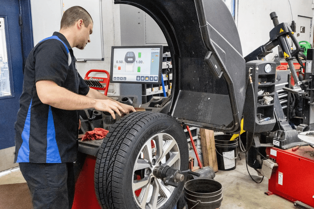 Car maintenance, auto repair in Glen Rock, PA by Cain and Sons’ Automotive. A technician uses advanced balancing equipment to ensure proper wheel alignment and smoother driving performance, showcasing precision and care in tire maintenance.