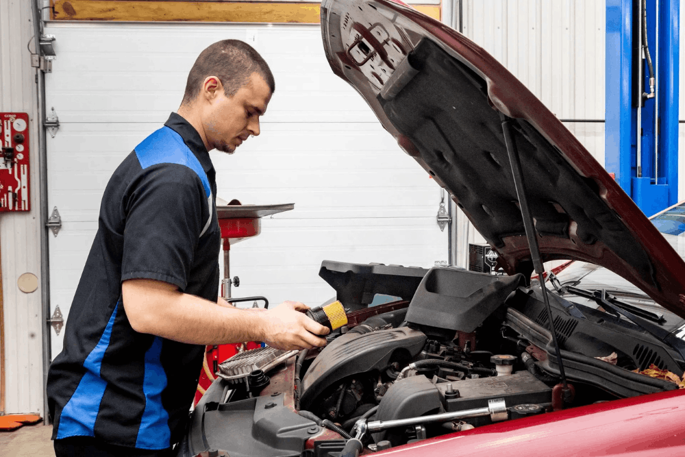 Car engine tune-up, auto repair in Glen Rock, PA by Cain and Sons' Automotive. Image of a technician inspecting a vehicle’s engine bay with a new air filter, highlighting improved performance, fuel efficiency, and reliable everyday driving.