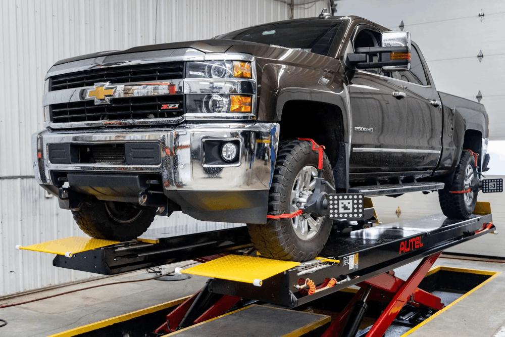 Chevy Silverado repair, auto repair in Glen Rock, PA by Cain and Sons' Automotive. Image of a Chevrolet Silverado on a precision alignment rack with digital sensors attached, highlighting accurate suspension adjustments, improved tire wear, and safer, smoother driving performance.